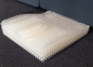 Seat with hard base and soft cushion layer and extra soft relief pads