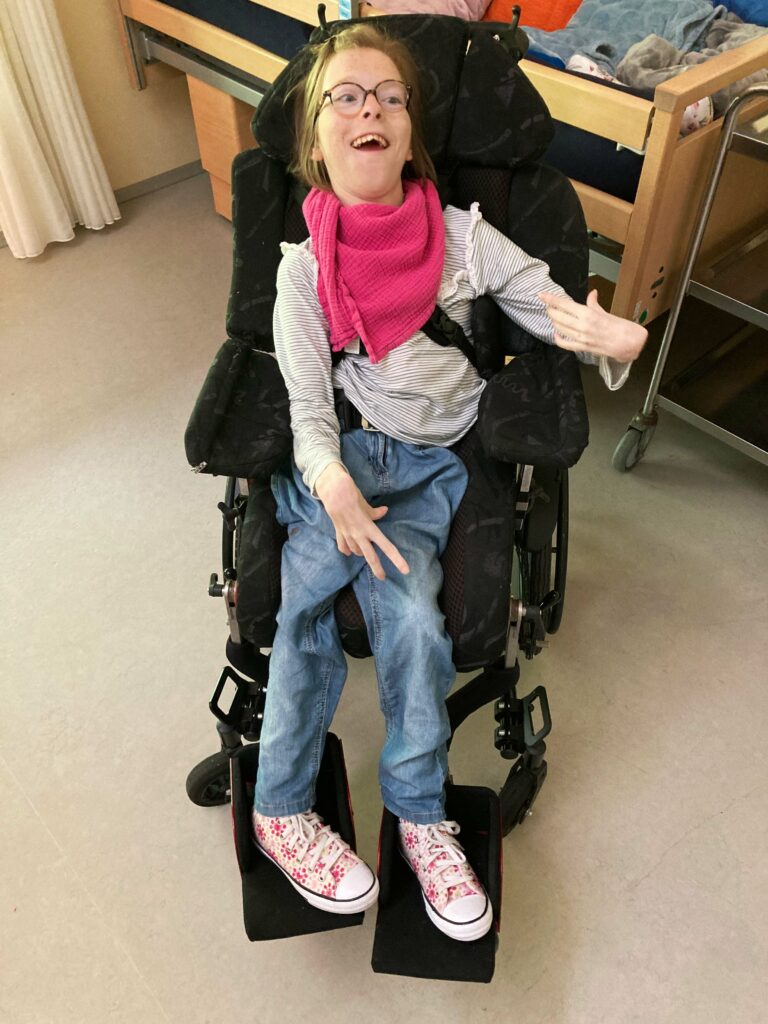 Esther in a traditional wheelchair seat