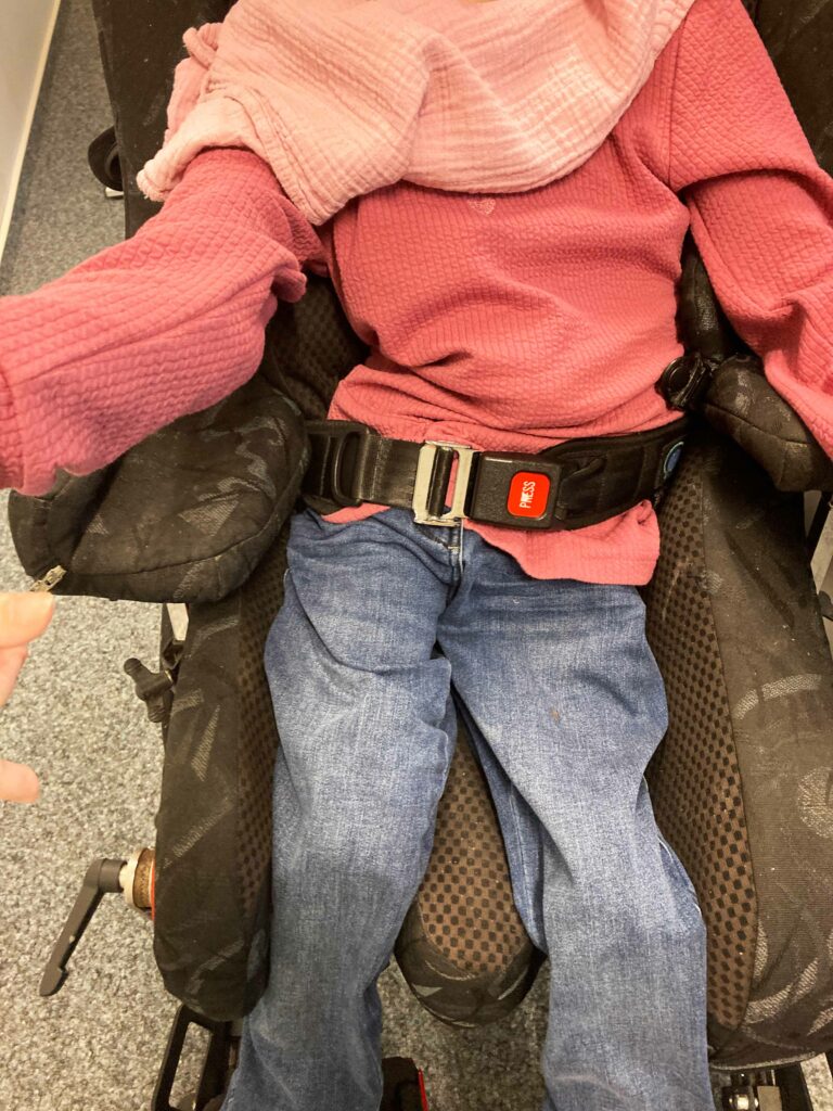 Esther in a traditional wheelchair seat