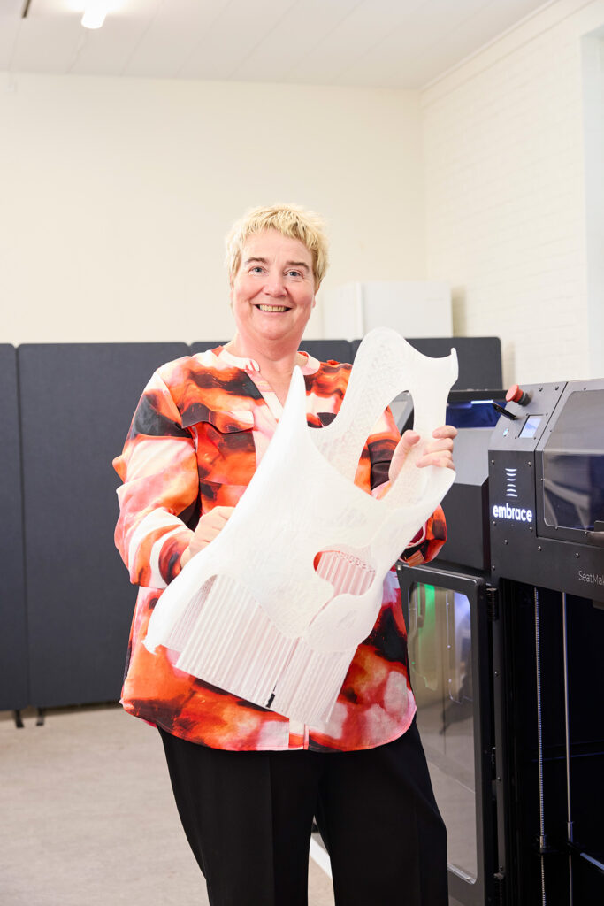 Woman holding a 3D printed corset